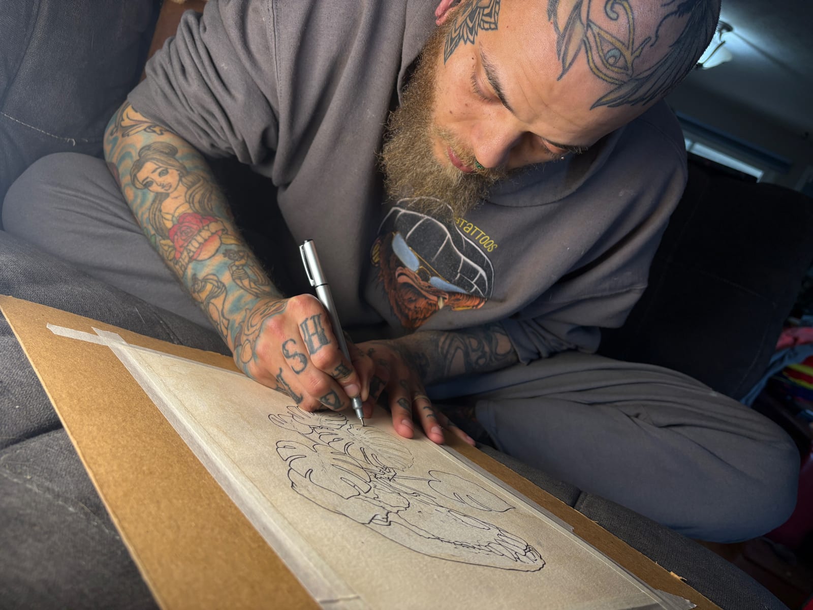 Columbus Ohio tattoo artist Spencer Holmes drawing a custom tattoo design at Fatmunk3y Tattoos