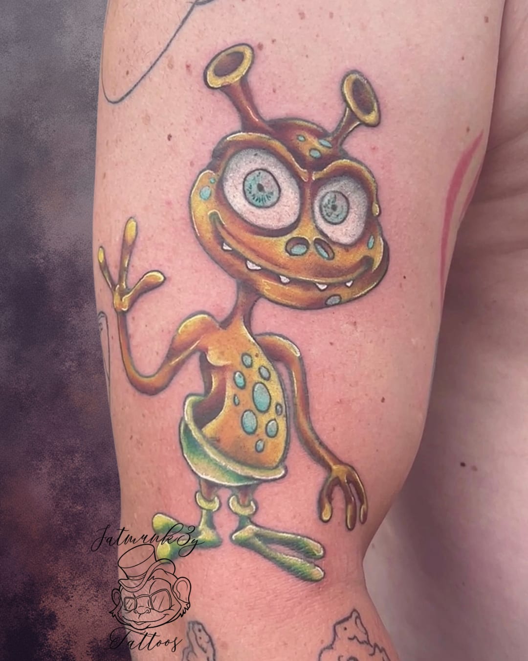 Custom color cartoon whimsical alien tattoo on arm by Spencer Holmes, Fatmunk3y Tattoos Columbus Ohio